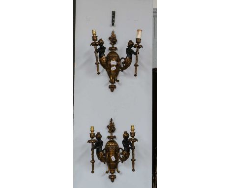 A pair of gilt and patinated figural twin light wall sconces, each 40cm high