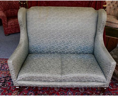 An Edwardian mahogany framed high wingbacked two seater sofa, 120cm by 75cm by 107cm