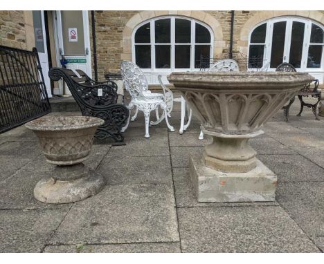 A cast stone Gothic style pedestal planter, together with a similar smaller example (2)Larger - with a crack running from one