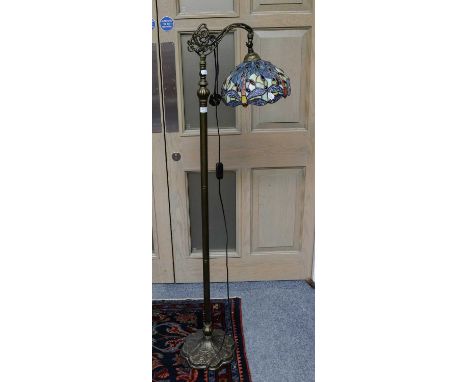 A modern standard lamp with a Tiffany style shade decorated with dragonflies, 161cm high