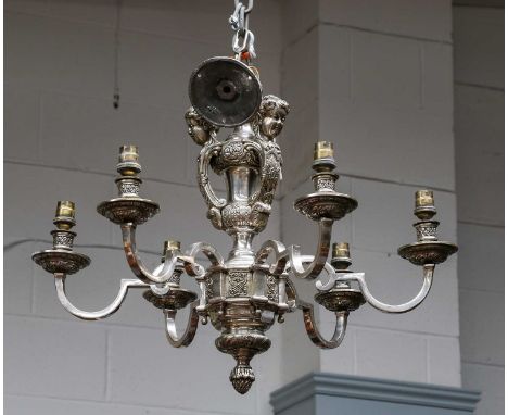 A silver six light electrolier the support issuing three masks over scroll arms, together with a pair of matching two light w