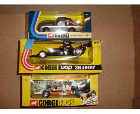 A group of three boxed Corgi to include two Formula 1 Racing cars and a James Bond Aston Martin (reproduction version) G-VG i