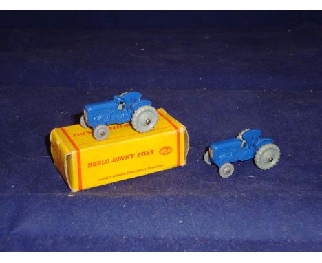 A Dublo Dinky 069 Massey Harris Tractor in original box together with a similar unboxed example. VG in a G box, where boxed. 