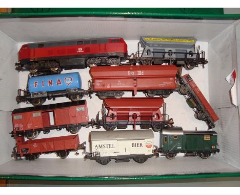 A Lima German Outline Diesel locomotive in DB red/grey livery, together with nine wagons by Fleischmann.  Unboxed. F-G