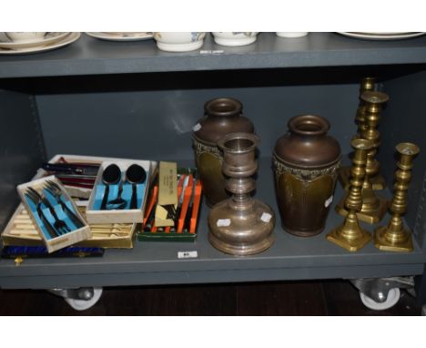 A pair of late 19th Century Art Nouveau copper and brass vases, measuring 22cm tall, together with four brass candlesticks, a