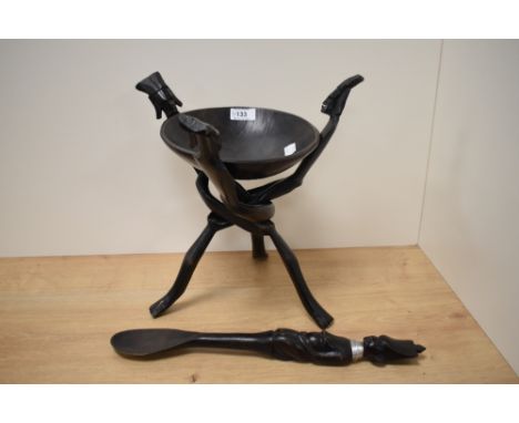 A primitive African hardwood bowl on folding tripod stand &amp; spoon of matching design