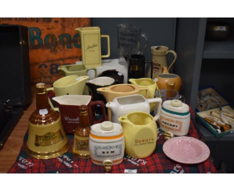 A selection of breweriana, including Crawfords Scotch Whisky jug, Bells whisky bell formed bottle, and two Senior service jug