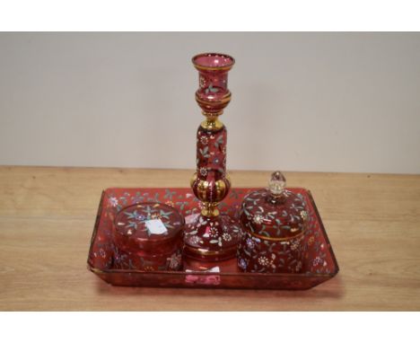 A 20th Century continental red glass dressing table set, with hand painted floral decoration, and to comprise candlestick, tw