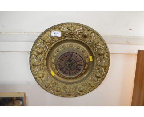 A brass embossed wall clock