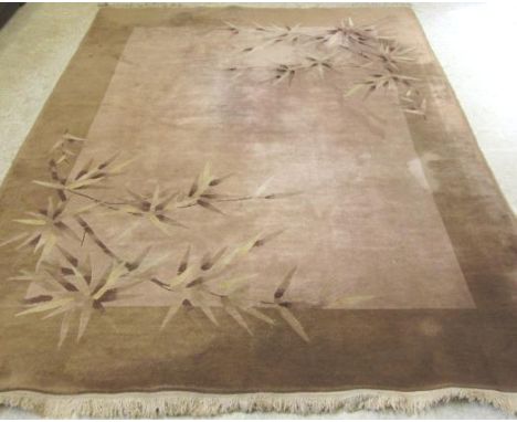 A CHINESE WASHED AND FRINGED CARPET, early 20th century, the pale mink field and wide coffee border overlaid with sprays of b