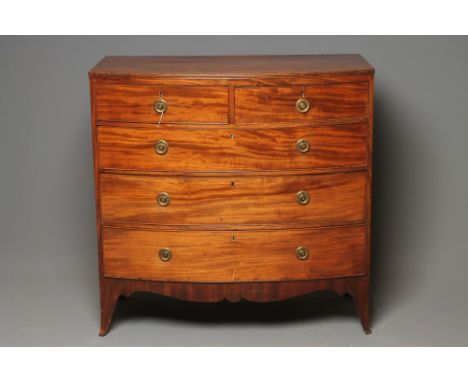 A REGENCY MAHOGANY CHEST, of bowed form with reeded edged top, two short over three long drawers with later brass ring handle