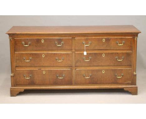 A MAHOGANY ENCLOSED DRESSER, 19th century, the moulded edged top over six drawers with brass drop handles, and flanked by qua