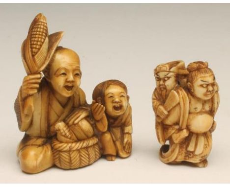 A JAPANESE IVORY NETSUKE, carved as a pot bellied man carrying a bearded man holding a fan on his back, 1 1/2" high, together