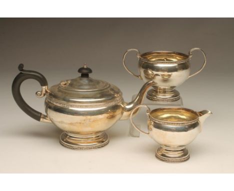 A THREE PIECE SILVER TEA SERVICE, maker probably George Brace & Co. Ltd., Birmingham 1931, of squat globular form with cast f