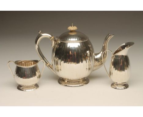 AN ART DECO THREE PIECE SILVER TEA SERVICE, maker W H Sparrow, Birmingham 1938, of panelled baluster form on domed bases, com