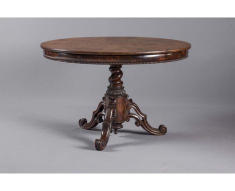 A VICTORIAN MAHOGANY CENTRE TABLE, the radially flame veneered circular top on cushion moulded frieze with beaded edge, raise