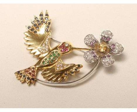 A MULTI-GEM SET 18CT GOLD HUMMINGBIRD BROOCH, the yellow gold bird with sapphire, diamond, ruby and emerald set wings, tail a