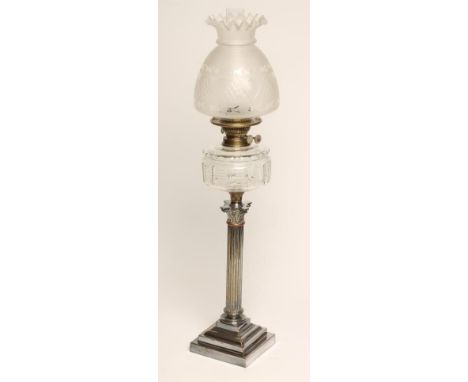 A LATE VICTORIAN PLATED ON COPPER AND BRASS OIL LAMP,  the slice cut cylindrical clear glass reservoir with Young's brass fit