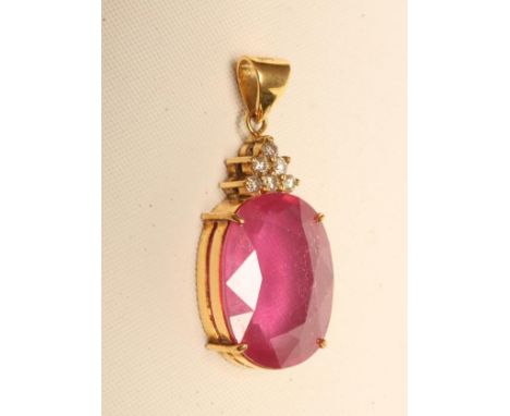A RUBY PENDANT, the oval facet cut stone of approximately 20cts, claw set below six small round brilliant cut diamonds to a p