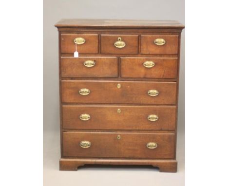 A GEORGIAN OAK CHEST, c.1800, the moulded edged top over three small frieze drawers, two drawers below over three long drawer