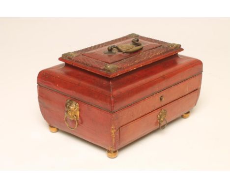 A REGENCY RED MOROCCO LEATHER SEWING CASKET of sarcophagus form, with stamped gilt metal spandrels and lion mask ring handles
