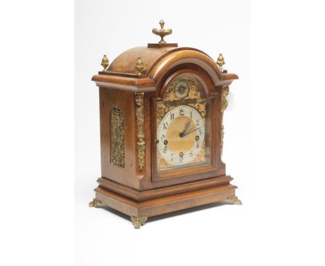 A WALNUT CASED MANTEL CLOCK by Hinde of Whitehaven, the three train chiming movement with anchor escapement striking on a gon