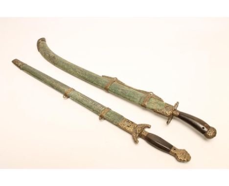 A CHINESE SWORD, with 20 1/2" curved and fullered blade, shaped horn grip, shagreen scabbard and stylised brass mounts, 28" l