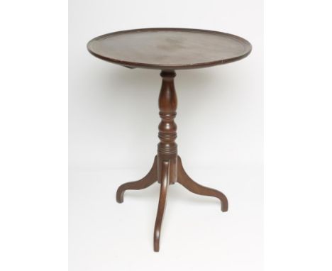 A MAHOGANY TRIPOD TABLE, early 19th century, the moulded edged dished circular top on baluster and ring turned stem, raised o