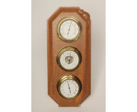 AN OAK WALL WEATHER STATION by Robert Thompson of canted oblong form mounted with a thermometer, barometer and hydrometer wit