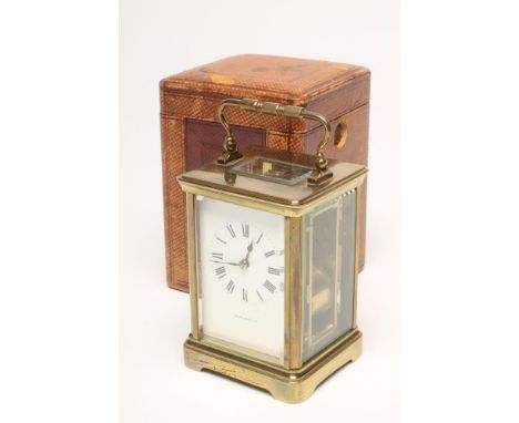 A BRASS CASED CARRIAGE CLOCK, the twin barrel movement with platform escapement striking on a gong, the white enamel dial wit