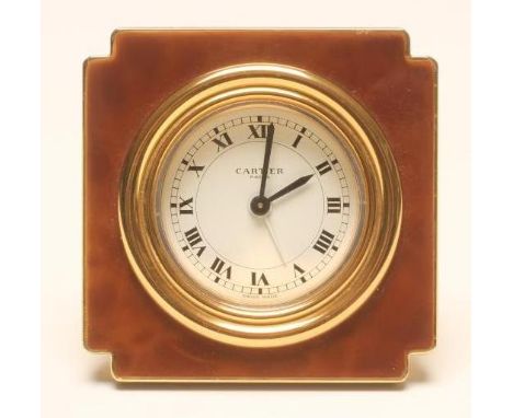 A CARTIER DRESSING TABLE ALARM CLOCK, the white enamel dial with black Roman numerals within a reeded bezel in a brown enamel