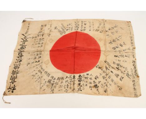 A JAPANESE SECOND WORLD WAR SURRENDER FLAG, the white field with central red sun, covered in script fanning out from the cent