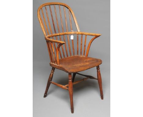 AN ASH AND ELM STICK BACK WINDSOR ARMCHAIR, early 19th century, the hooped back with inscribed line, shaped arm supports, sad