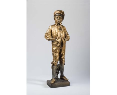 A GOLDSCHEIDER BRONZED EARTHENWARE FIGURE, c.1900, modelled as a young aristocratic boy wearing a fur hat, lace cravat and bu