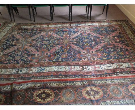 A Persian carpet with stylised medallions, 144" x 77"