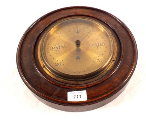 A circular oak brass dial barometer, signed Deacon & Sons, Luton