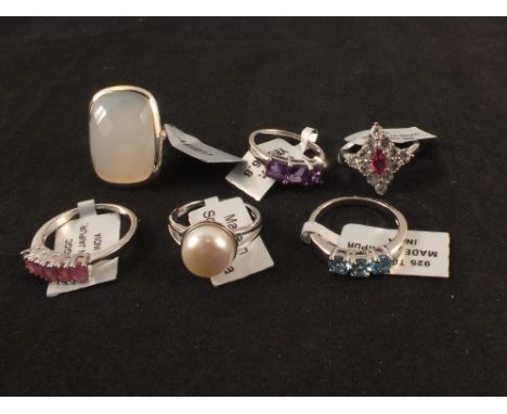 Six stone set silver rings including pink topaz, pearl, quartz etc