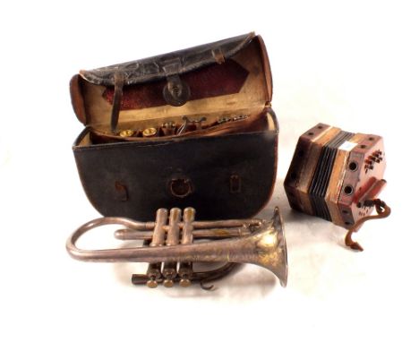 A cased Besson trumpet and accessories plus a small accordion