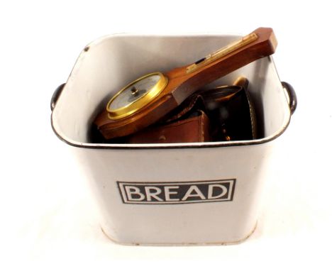 An enamel bread bin containing brassware etc