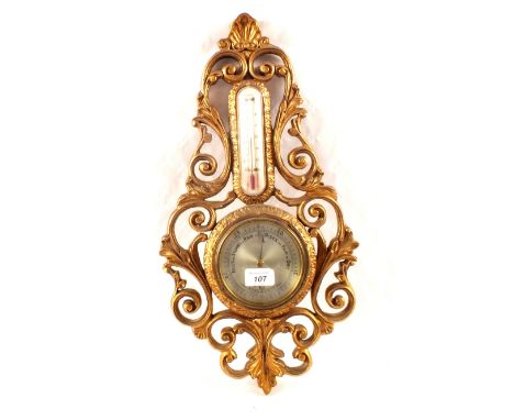 An aneroid barometer in gilt case