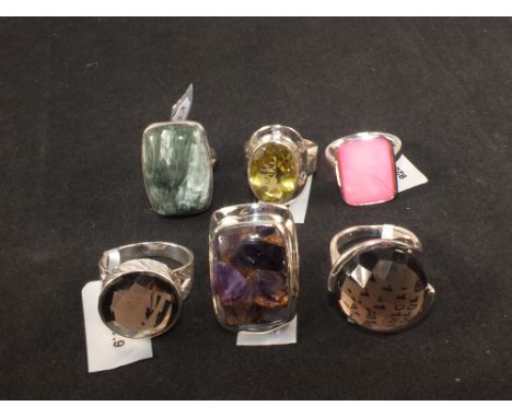 A group of six silver stone set rings including quartz, agate and mother of pearl