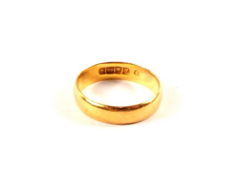 A 22ct gold wedding band (misshapen), size K