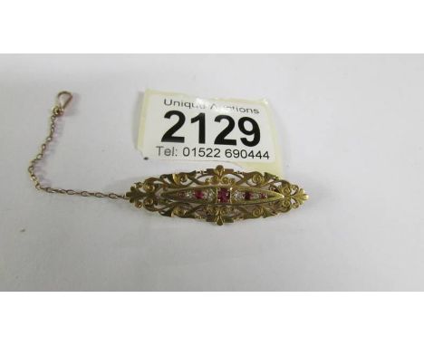 An antique diamond and ruby brooch in 15ct gold, total weight 5.4 grams. ****Condition report**** Chain and clip in good cond