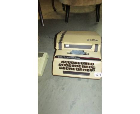 A vintage Petite Super International typewriter.