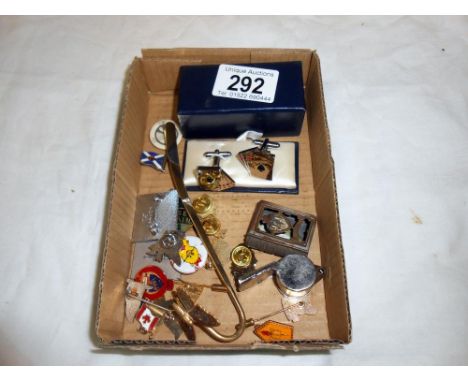 A collection of pin badges, playing cards, cufflinks etc.