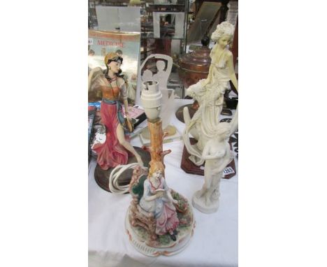 A figural table lamp and 4 assorted figures.