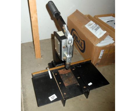 A manual framing press for attaching hangers and rings to picture frame backboards