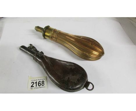 A copper gunpowder/shot flask together with a leather gunpowder/shot flask.