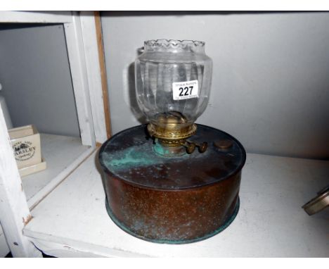 An unusual copper oil lamp with shade