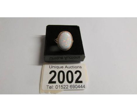 A large oval opal 9ct gold ring size O half, (opal reconstituted).